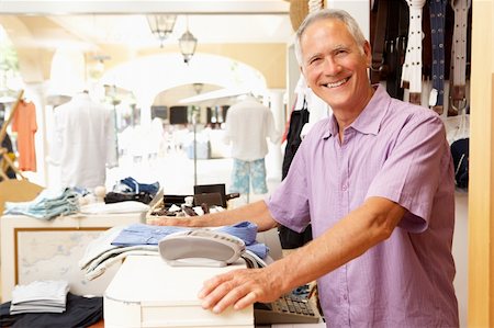 Male Sales Assistant At Checkout Of Clothing Store Stock Photo - Budget Royalty-Free & Subscription, Code: 400-06418610