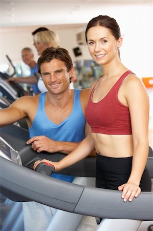 simsearch:400-06418716,k - Woman Working With Personal Trainer On Running Machine In Gym Foto de stock - Royalty-Free Super Valor e Assinatura, Número: 400-06418710