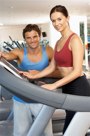 simsearch:400-06418716,k - Woman Working With Personal Trainer On Running Machine In Gym Foto de stock - Royalty-Free Super Valor e Assinatura, Número: 400-06418712