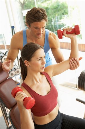 simsearch:400-06418716,k - Young Woman Working With Weights In Gym With Personal Trainer Foto de stock - Royalty-Free Super Valor e Assinatura, Número: 400-06418734