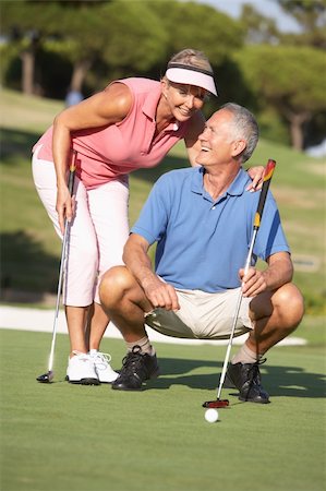 senior couple golf - Senior Couple Golfing On Golf Course Lining Up Putt On Green Stock Photo - Budget Royalty-Free & Subscription, Code: 400-06418793