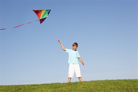 Young boy poses with kite in a field Stock Photo - Budget Royalty-Free & Subscription, Code: 400-06419327
