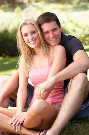 Portrait Of Young Couple Relaxing In Park Stock Photo - Budget Royalty-Free & Subscription, Code: 400-06419529