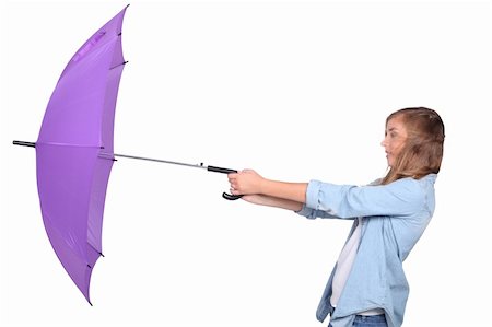 Young woman struggling with a purple umbrella on a windy day Stock Photo - Budget Royalty-Free & Subscription, Code: 400-06419716