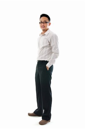 Full body of a smiling young Asian executive standing against isolated white background Stock Photo - Budget Royalty-Free & Subscription, Code: 400-06410669