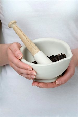 woman holding pestle and mortar with black peppercorns Stock Photo - Budget Royalty-Free & Subscription, Code: 400-06424073
