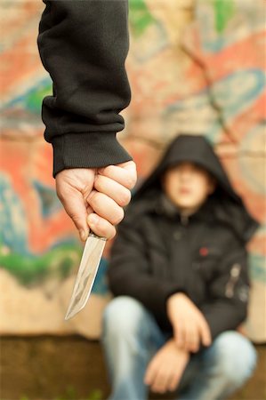 Boy looks at a man with a knife Foto de stock - Royalty-Free Super Valor e Assinatura, Número: 400-06425195