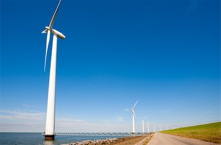 Wind turbines along the dike in the IJsselmeer in Flevoland, the Netherlands Stock Photo - Budget Royalty-Free & Subscription, Code: 400-06425474