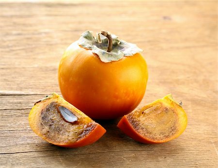 Persimmon fruit on a wooden table Stock Photo - Budget Royalty-Free & Subscription, Code: 400-06425710