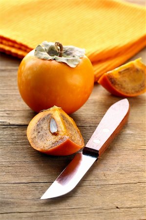 Persimmon fruit on a wooden table Stock Photo - Budget Royalty-Free & Subscription, Code: 400-06425711