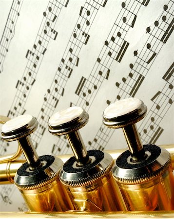 simsearch:400-05304831,k - Three trumpet valves in front of notes Stock Photo - Budget Royalty-Free & Subscription, Code: 400-06426244