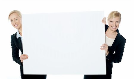 simsearch:400-06695536,k - Female business representatives presenting a clipboard isolated over white background Stock Photo - Budget Royalty-Free & Subscription, Code: 400-06426702