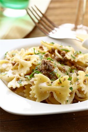 rigatoni parmesan - farfalle pasta with beef sauce  on  plate with  fork Stock Photo - Budget Royalty-Free & Subscription, Code: 400-06426995