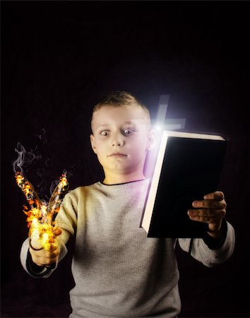 Kid looking at a slingshot on fire and trying to make a decision Stock Photo - Budget Royalty-Free & Subscription, Code: 400-06427724