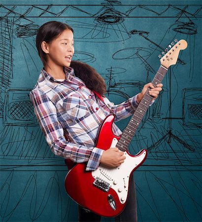 Asian girl playing the guitar and singing the song Stock Photo - Budget Royalty-Free & Subscription, Code: 400-06428286