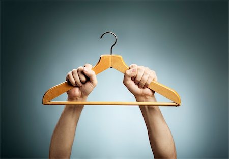 Man holding an old wooden clothes hanger in his hands. Stock Photo - Budget Royalty-Free & Subscription, Code: 400-06428948