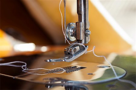 Closeup of a sewing machine threading. Foot, needle and thread. Stock Photo - Budget Royalty-Free & Subscription, Code: 400-06429683