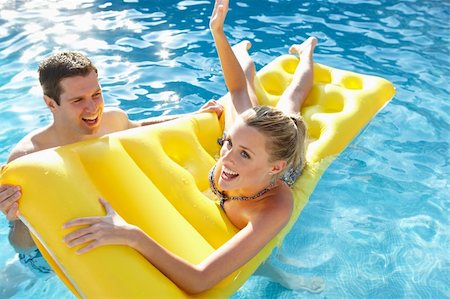 Young couple having fun in pool Stock Photo - Budget Royalty-Free & Subscription, Code: 400-06420158