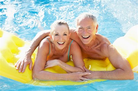 Senior couple having fun in pool Stock Photo - Budget Royalty-Free & Subscription, Code: 400-06420159