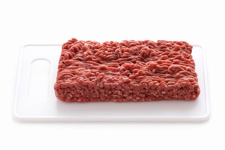 steak haché - viande de bœuf hachée crue sur un fond blanc isolé de planche à découper Photographie de stock - Aubaine LD & Abonnement, Code: 400-06420172
