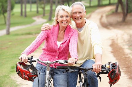 Senior couple riding bicycle in park Foto de stock - Super Valor sin royalties y Suscripción, Código: 400-06420434