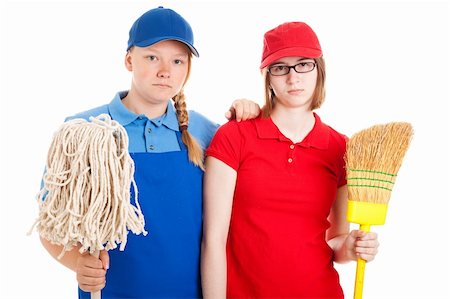 simsearch:400-06685903,k - Two serious looking teenage girls, dressed in uniforms for menial jobs and holding a broom and mop.  Isolated on white. Fotografie stock - Microstock e Abbonamento, Codice: 400-06420508