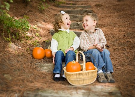 Cute Young Brother and Sister Children Sitting on Wood Steps Laughing with Pumpkins in a Basket. Foto de stock - Super Valor sin royalties y Suscripción, Código: 400-06420864