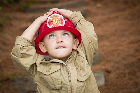 fire help - Happy Adorable Child Boy with Fireman Hat Playing Outside. Stock Photo - Budget Royalty-Free & Subscription, Code: 400-06420872