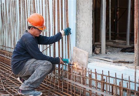 Authentic construction worker cutting steel rods with electrical saw Stock Photo - Budget Royalty-Free & Subscription, Code: 400-06420929