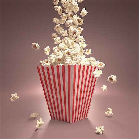 Dropping popcorn in striped classic package. Foto de stock - Royalty-Free Super Valor e Assinatura, Número: 400-06421053