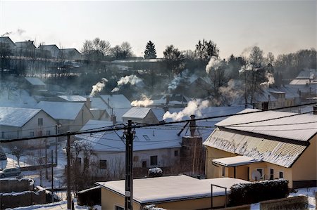 non ecologic smoking chimneys in small village Stock Photo - Budget Royalty-Free & Subscription, Code: 400-06421803