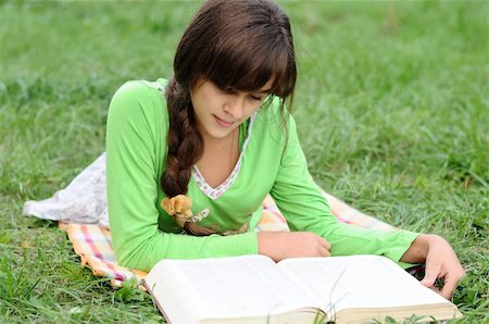 reading book open air - Girl reading a book lying on the grass Stock Photo - Budget Royalty-Free & Subscription, Code: 400-06422820