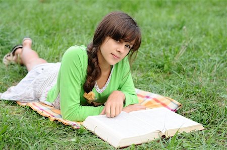 reading book open air - Girl reading a book lying on the grass Stock Photo - Budget Royalty-Free & Subscription, Code: 400-06422821