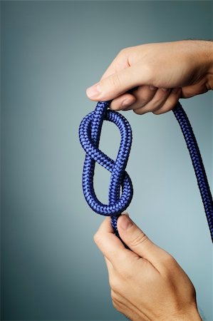 stopper - Man holding blue rope with figure of eight knot in his hands. Stock Photo - Budget Royalty-Free & Subscription, Code: 400-06422990