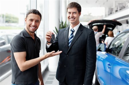 Seller gives the buyer of the car keys Stock Photo - Budget Royalty-Free & Subscription, Code: 400-06456389