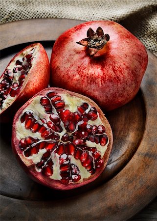 Pomegranate in rustic wooden plate Stock Photo - Budget Royalty-Free & Subscription, Code: 400-06456645