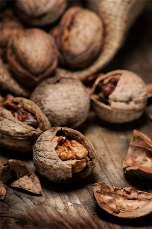 Cracked walnuts on rustic wooden table Stock Photo - Budget Royalty-Free & Subscription, Code: 400-06456646