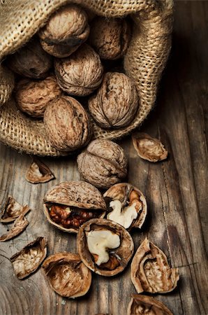 Cracked walnuts on rustic wooden table Stock Photo - Budget Royalty-Free & Subscription, Code: 400-06456641