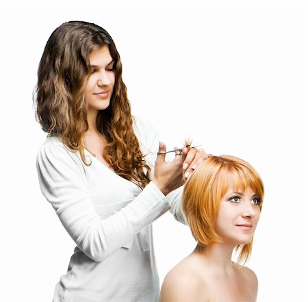 Young nice woman hairdresser makes hairstyle for a girl isolated on white background Foto de stock - Super Valor sin royalties y Suscripción, Código: 400-06457202