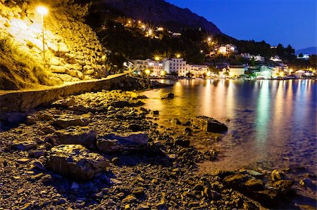 simsearch:400-07248217,k - Illuminated Rocky Beach and Transparent Mediterranean Sea in the Night, Croatia Foto de stock - Royalty-Free Super Valor e Assinatura, Número: 400-06457352