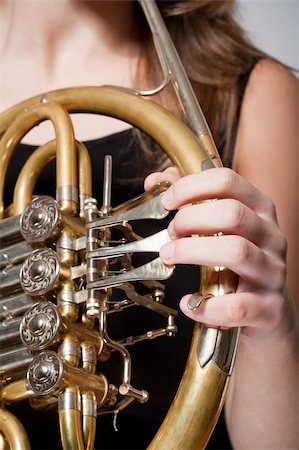 simsearch:400-07338880,k - detail of a female musician«s fingers playing concert french horn Stock Photo - Budget Royalty-Free & Subscription, Code: 400-06457649