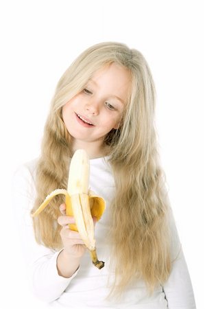 young blond girl holds banana against white bachground Stock Photo - Budget Royalty-Free & Subscription, Code: 400-06457942