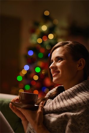 pic of drinking celebration for new year - Thoughtful woman sitting chair and drinking hot beverage in front of Christmas tree Stock Photo - Budget Royalty-Free & Subscription, Code: 400-06458867