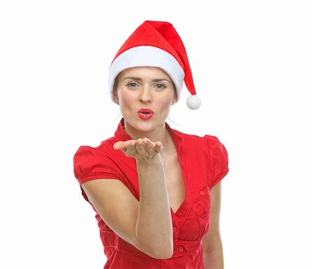santa christmas hat women - Smiling young woman in Santa hat blowing air kiss Stock Photo - Budget Royalty-Free & Subscription, Code: 400-06458874