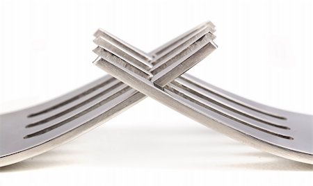 Two shiny forks cross on white surface Foto de stock - Royalty-Free Super Valor e Assinatura, Número: 400-06458944