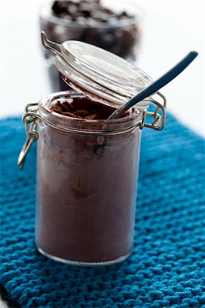 Close up of cocoa powder and spoon in glass jar with coffee beans in background Stock Photo - Budget Royalty-Free & Subscription, Code: 400-06459154