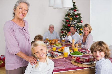 simsearch:400-06871557,k - Smiling grandmother and granddaughter standing beside the dinner table at christmas Photographie de stock - Aubaine LD & Abonnement, Code: 400-06459307