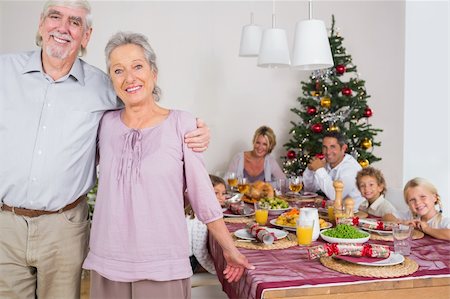 simsearch:400-06871557,k - Smiling grandparents standing by the dinner table at christmas time Photographie de stock - Aubaine LD & Abonnement, Code: 400-06459309