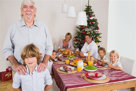 simsearch:400-06871557,k - Grandfather and grandson standing beside the dinner table at christmas time Photographie de stock - Aubaine LD & Abonnement, Code: 400-06459312