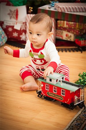 Cute Infant Mixed Race Baby Enjoying Christmas Morning Near The Tree. Stock Photo - Budget Royalty-Free & Subscription, Code: 400-06464552